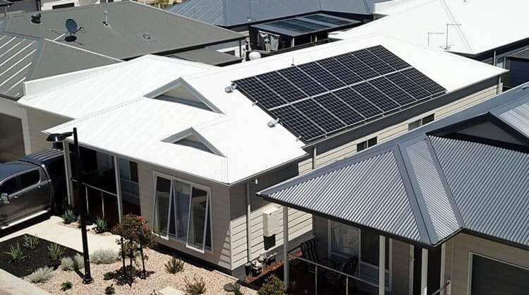 Solar panels on white tin roof new home