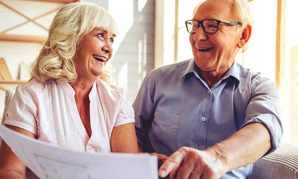 happy old couple read ower bill together